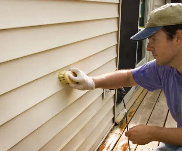 man-repairing-vinyl-siding